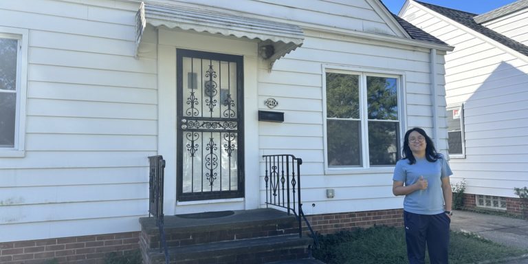 person-standing-outside-house